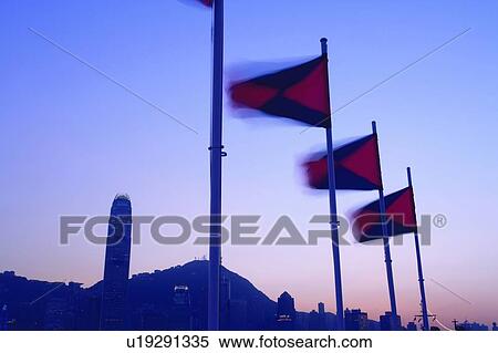 Row of flags, Hong Kong Victoria Harbour and city skyline at dusk View Large Photo Image Stock Photography - Row of flags, Hong Kong Victoria Harbour and city skyline at dusk. Fotosearch