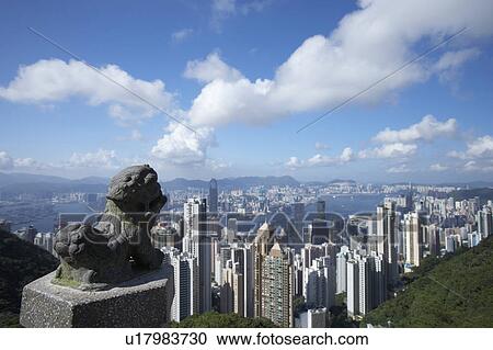 Stock Image - Stone Lion Statue at Victoria Peak and Hong Kong's Central District. Fotosearch