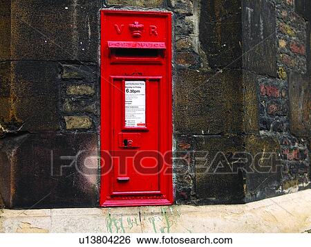 A red post box stands in a stone wall View Large Photo Image Stock Photograph - A red post box stands in a stone wall. Fotosearch