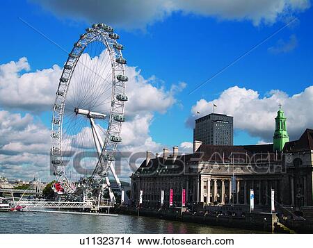 The London Eye ferris wheel on the banks of the Thames River. View Large Photo Image Picture - The London Eye ferris wheel on the banks of the Thames River.. Fotosearch