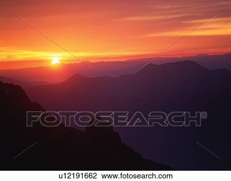 Stock Image - Sunrise on mountain peak in Japan. Fotosearch