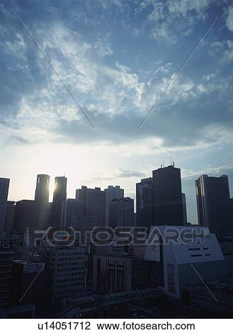 Stock Image - Skyline of Shinjuku at sunset. Fotosearch