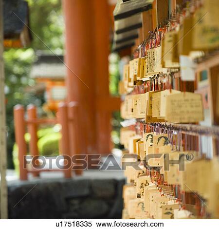 Stock Photography - Pictorial offerings hanging at shrine. Fotosearch