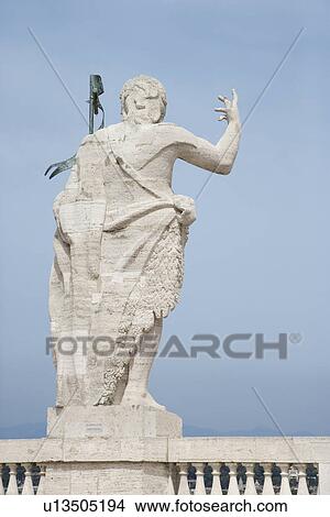 Back view of Roman statue with blue sky in Rome, Italy. View Large Photo Image Picture - Back view of Roman statue with blue sky in Rome, Italy.. Fotosearch