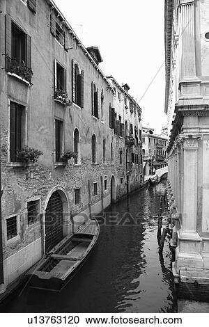 Canal with boat and buildings in Venice, Italy. View Large Photo Image Stock Image - Canal with boat and buildings in Venice, Italy.. Fotosearch