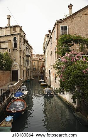 Canal with boats and buildings in Venice, Italy. View Large Photo Image Picture - Canal with boats and buildings in Venice, Italy.. Fotosearch