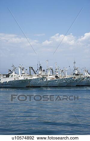 Stock Image - Fleet of boats moored together.. Fotosearch