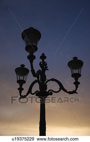 Stock Photo - Streetlamp with sunset sky in background in Rome, Italy.. Fotosearch