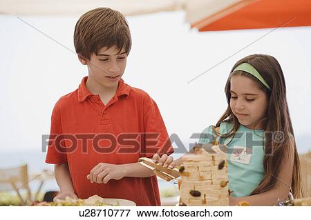 Boy and girl at buffet View Large Photo Image Stock Photo - Boy and girl at buffet. Fotosearch