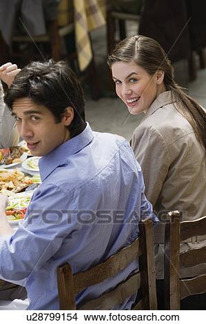 Couple at a restaurant table View Large Photo Image Picture - Couple at a restaurant table. Fotosearch