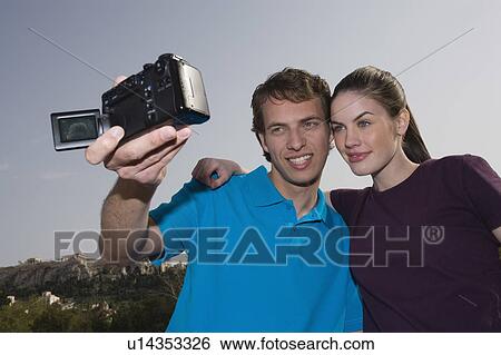 Couple at archaeological site photographing themselves View Large Photo Image Stock Photograph - Couple at archaeological site photographing themselves. Fotosearch