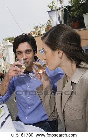 Stock Image - Couple drinking white wine. Fotosearch