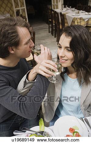 Couple drinking wine with linked arms View Large Photo Image Stock Photo - Couple drinking wine with linked arms. Fotosearch