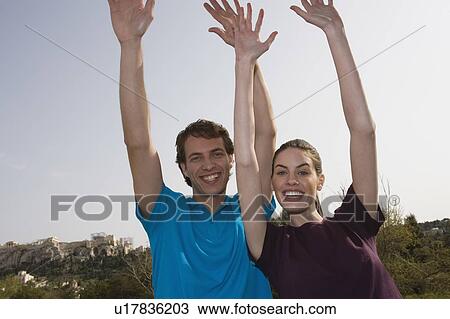 Couple with hands up View Large Photo Image Stock Image - Couple with hands up. Fotosearch