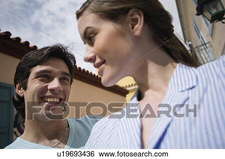 Man and woman smiling at each other View Large Photo Image Stock Photograph - Man and woman smiling at each other. Fotosearch