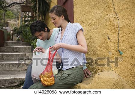 Stock Photo - Man and woman with a picnic lunch. Fotosearch