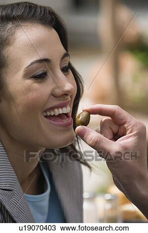 Man's hand feeding woman an olive View Large Photo Image Stock Image - Man's hand feeding woman an olive. Fotosearch
