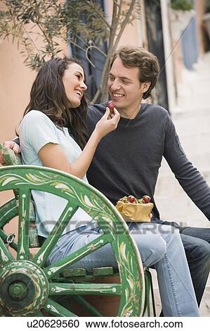Woman offering a strawberry to man View Large Photo Image Stock Image - Woman offering a strawberry to man. Fotosearch