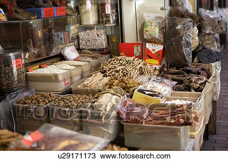 Stock Image - Dried herbs and goods on display at Herbal Medicine Street on Ko Shing Street, Central District, Hong Kong. Fotosearch