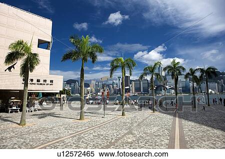 Stock Photography - People outside the Hong Kong Cultural Centre in Tsim Sha Tsui, Kowloon, Hong Kong. Fotosearch