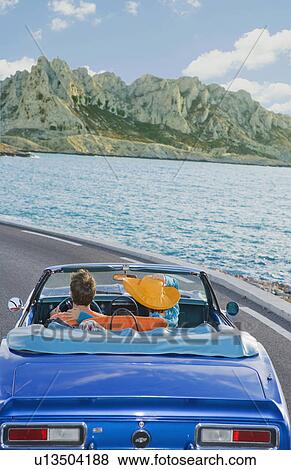 Man and woman driving by coast. View Large Photo Image Stock Photo - Man and woman driving by coast.. Fotosearch