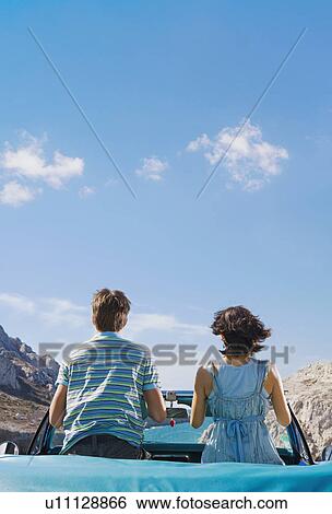 Man and woman in car looking out to sea. View Large Photo Image Stock Photograph - Man and woman in car looking out to sea.. Fotosearch