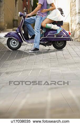 Stock Photography - Man and woman on scooter.. Fotosearch