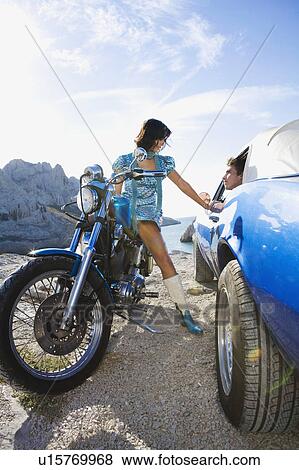Man in car woman on motorbike. View Large Photo Image Stock Photo - Man in car woman on motorbike.. Fotosearch