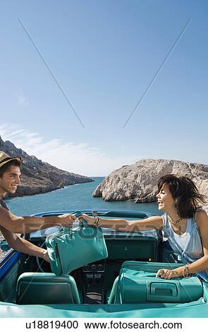 Woman handing man bag over car. View Large Photo Image Stock Image - Woman handing man bag over car.. Fotosearch