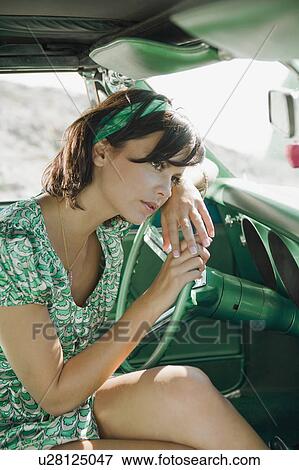 Woman in car looking pensive. View Large Photo Image Stock Photo - Woman in car looking pensive.. Fotosearch