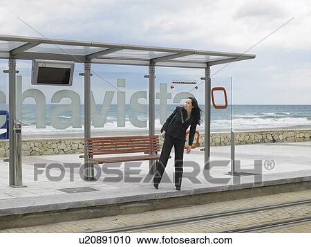 Young businesswoman waiting at tram stop View Large Photo Image Stock Image - Young businesswoman waiting at tram stop. Fotosearch