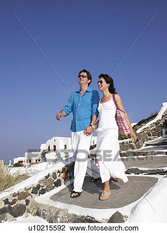 Couple climbing down the stairs View Large Photo Image Stock Image - Couple climbing down the stairs. Fotosearch