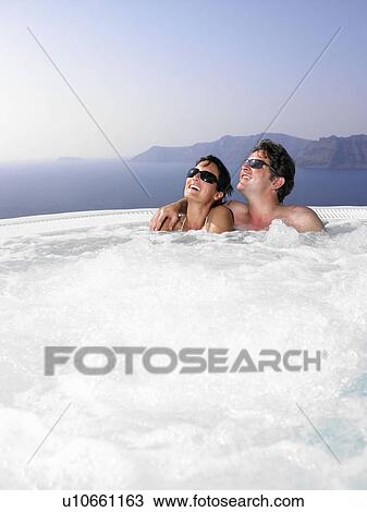 Stock Image - Couple in hot tub. Fotosearch