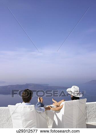 Couple looking at the sea view View Large Photo Image Stock Photo - Couple looking at the sea view. Fotosearch