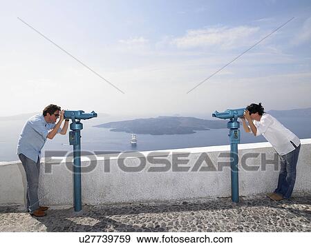 Couple looking through spyglasses View Large Photo Image Stock Photo - Couple looking through spyglasses. Fotosearch