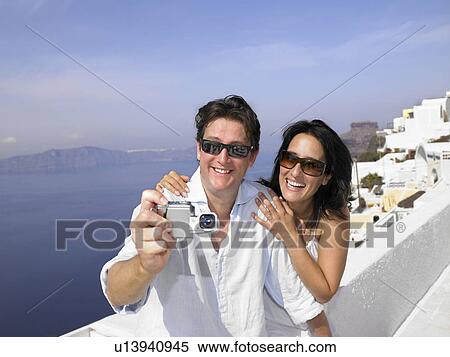Stock Photography - Couple taking pictures, sea view. Fotosearch