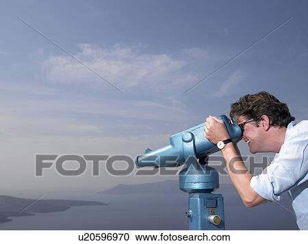 Stock Image - Man looking through spyglasses. Fotosearch