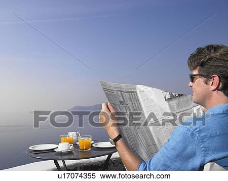 Man reading newspaper at breakfast View Large Photo Image Stock Photography - Man reading newspaper at breakfast. Fotosearch