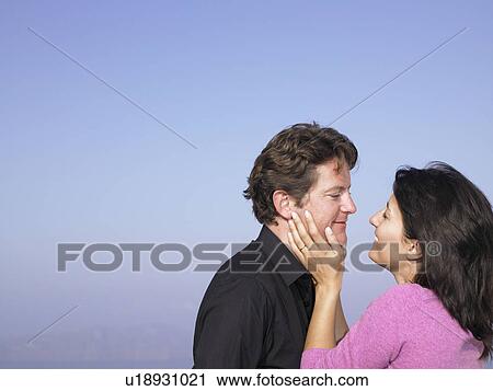 Men and woman smiling at each other View Large Photo Image Stock Image - Men and woman smiling at each other. Fotosearch