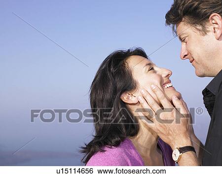 Men and woman smiling at each other View Large Photo Image Stock Photograph - Men and woman smiling at each other. Fotosearch