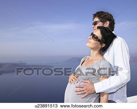 Pregnant woman and husband, sea view View Large Photo Image Stock Image - Pregnant woman and husband, sea view. Fotosearch