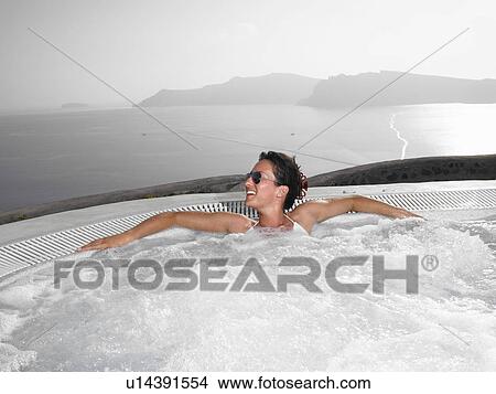 Picture - Woman in hot tub. Fotosearch