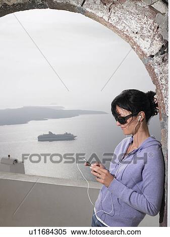 Woman listening to music with ear phones View Large Photo Image Stock Photography - Woman listening to music with ear phones. Fotosearch