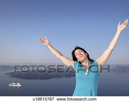 Woman stretching her arms, sea view View Large Photo Image Stock Photo - Woman stretching her arms, sea view. Fotosearch