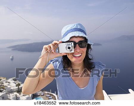 Stock Image - Woman taking a picture. Fotosearch
