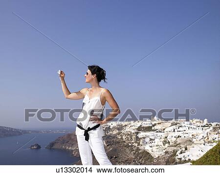 Picture - Woman taking pictures of the view. Fotosearch
