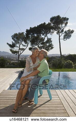 Older couple hugging on terrace. View Large Photo Image Stock Image - Older couple hugging on terrace.. Fotosearch