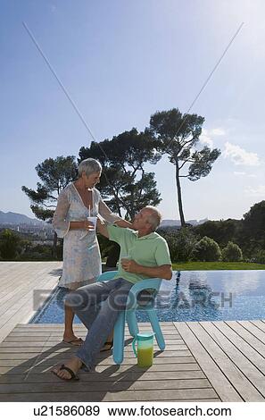 Older couple hugging on terrace. View Large Photo Image Stock Photo - Older couple hugging on terrace.. Fotosearch