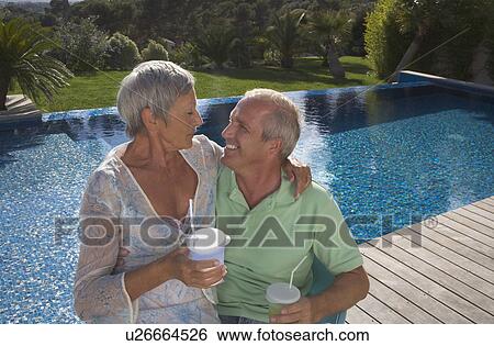 Older couple hugging on terrace. View Large Photo Image Stock Photograph - Older couple hugging on terrace.. Fotosearch
