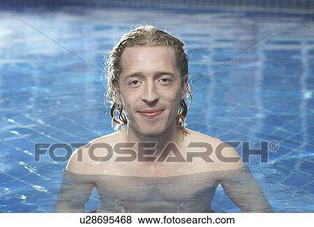 Stock Photo - Portrait of a man in a swimming pool.. Fotosearch